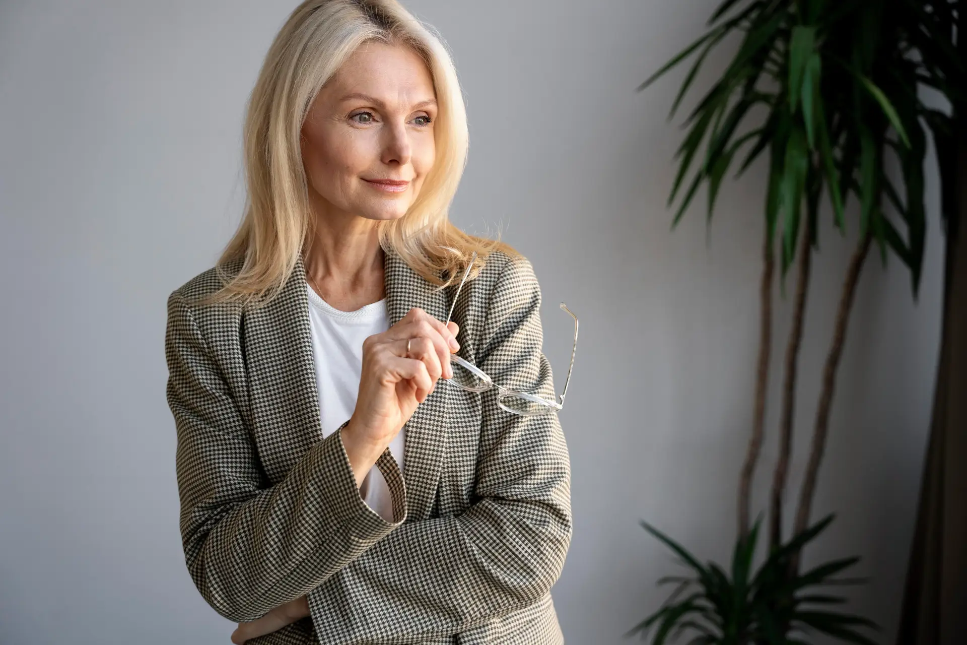 Woman smiling holding glasses