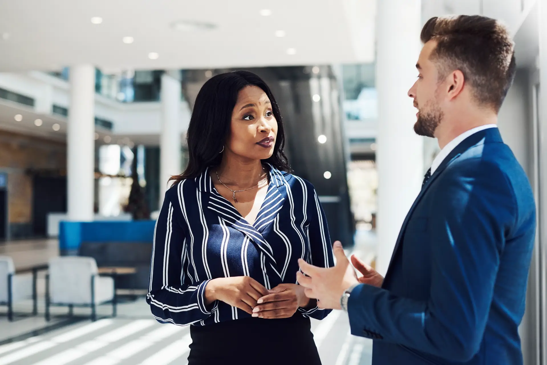 Man and woman discussing, front office